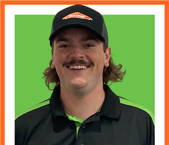 Cooper Wilson at SERVPRO in uniform against a green background
