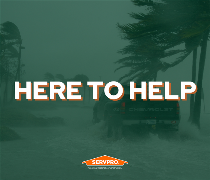 flooding, palm trees, truck driving down flooded road, text reads here to help, SERVPRO of East Fort Worth logo